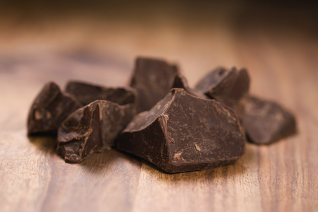 dark chocolate chunks on wood tableの写真素材