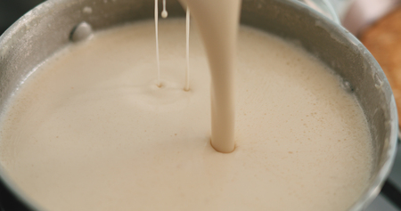 closeup checking pancakes doughtの写真素材