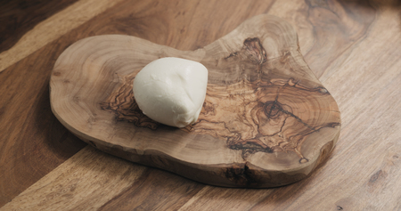 mozzarella cheese on wooden boardの写真素材