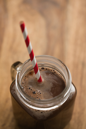 warm cocoa in jar mug on a wooden table, shallow focusの写真素材