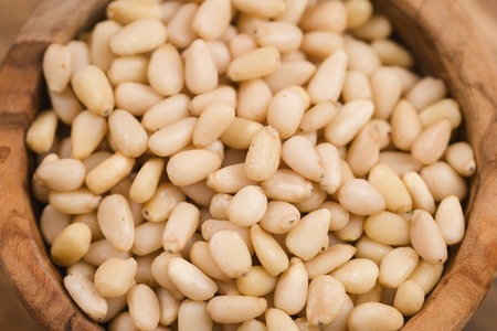 pine nuts in wood bowl, shallow focusの写真素材