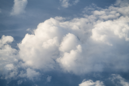 flying above the clouds in middayの写真素材