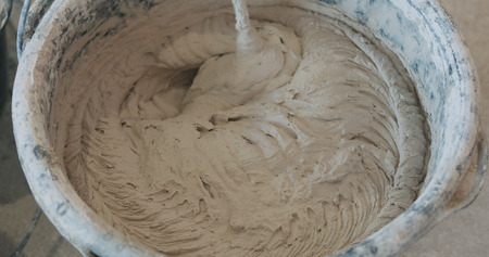 mixing concrete plaster with electric mixerの写真素材