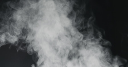 vapor steam rising over black backgroundの写真素材