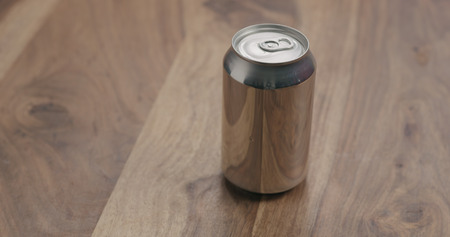 aluminium can with soda drink on wood table