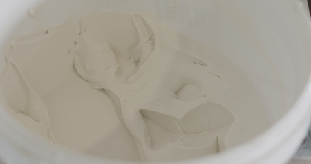 white putty ready to apply in a bucket