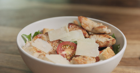 parmesan flakes falling on caesar saladの写真素材