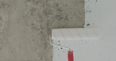 painting concrete ceiling into white with rollerの写真素材