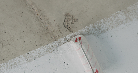 painting concrete ceiling into white with rollerの写真素材