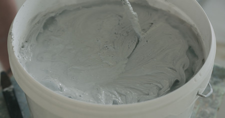 closeup mixing gray decorative concrete plasterの写真素材