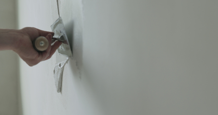closeup worker applying decorative concrete plaster on the wallの写真素材