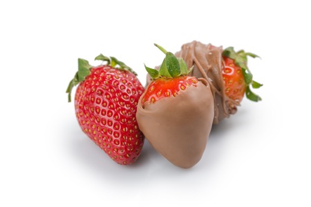 Fresh ripe strawberry covered with milk chocolate isolated on whiteの写真素材