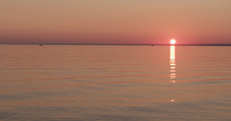 small waves on a beach at sunsetの写真素材