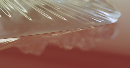 closeup peeling off protective film from a carの写真素材