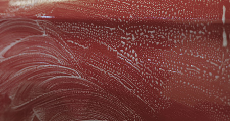 Closeup focus red car wash degreasing paint soakの写真素材