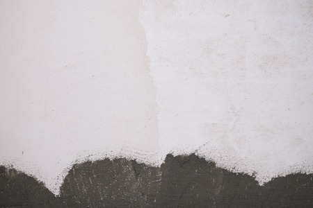 freshly plastered interior wall with mortar on the bottomの写真素材