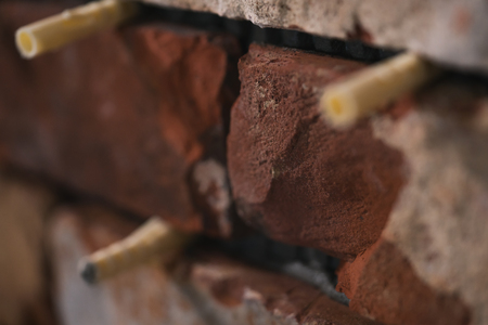 process of making old brick wall from cuts of vintage bricks, shallow focus