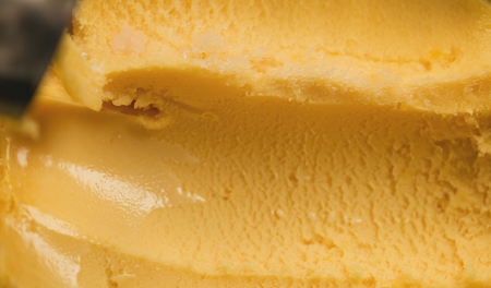 Close-up scooping orange sorbetの写真素材