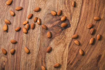 Almond nuts scattered on the table, shallow focusの写真素材