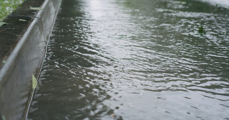 water streams on the street after rain