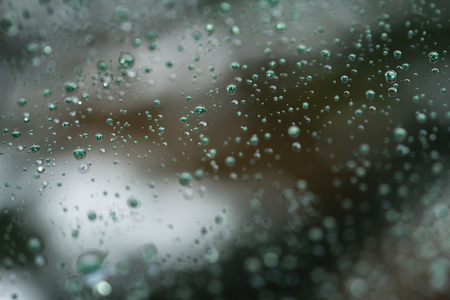 Closeup rain drops on glass with hydrophobic coatingの写真素材
