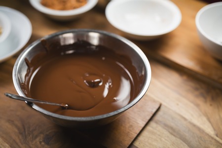 Melted dark chocolate in a steel bowlの写真素材