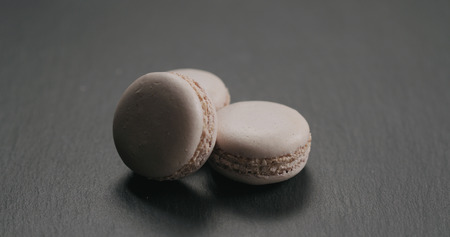 Beige macarons on slate background, wide photoの写真素材