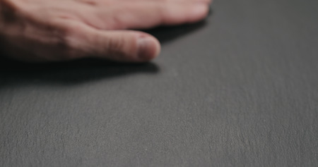 man hand check quality of slate stone surfaceの写真素材