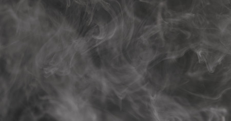 Slow motion closeup vapor floating in air on black background