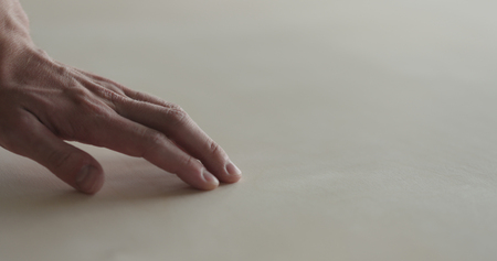 closeup man hand touches plywood to check surface, wide photoの写真素材