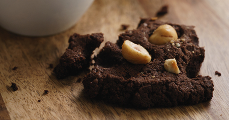 Closeup   of cup of fresh espresso with homemade chocolate cookie with hazelnutsの写真素材