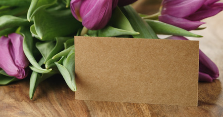 Closeup   of bouquet of purple tulips on wood tableの写真素材