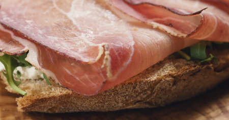 Closeup   of italian sandwich with speck, arugula salad and beerの写真素材
