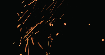 hot sparks falling from above black backgroundの写真素材