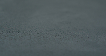 decorative dark concrete background with shallow focusの写真素材