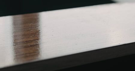 applying oil finish with brush to black walnut board