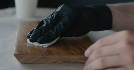 woodworker applying oil finish to olive wood board