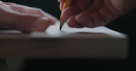 Woodworker measuring and draw line on black walnut boardの写真素材