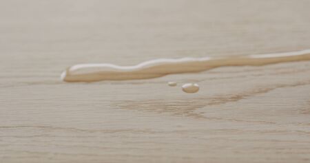 pour oil onto white oak boardの写真素材