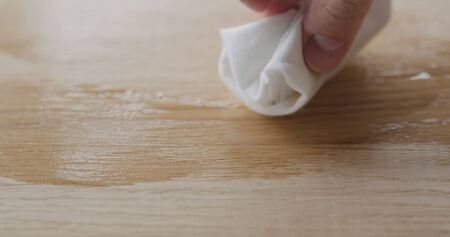 applying oil finish to oak surface with cloth
