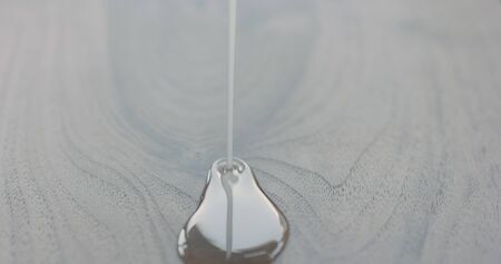 pour oil onto black walnut boardの写真素材