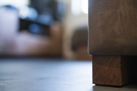 Low angle interior shot with blurred background and couch leg in frontの写真素材