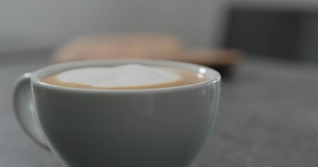 pouring steamed milk anto espresso to make capuccinoの写真素材