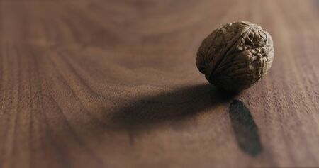 inshell walnut on walnut wood surfaceの写真素材