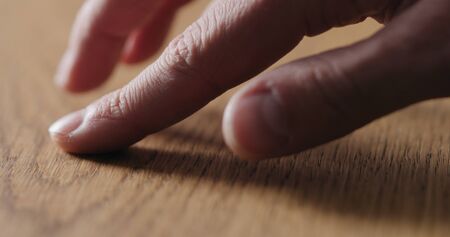 man hand touch oil finished oak wood surface, wide photo
