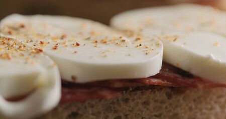 Extreme closeup put top on slami mozzarella sandwich, wide photo