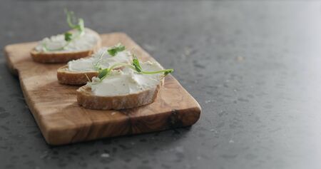 ciabatta with cream cheese and pea sprouts, wide photoの写真素材