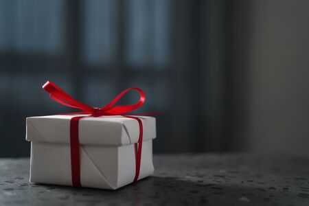White gift box red ribbon on terrazzo countertop with copy spaceの写真素材