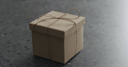 brown paper gift box on terrazzo countertop, wide photo