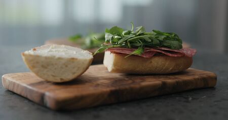 arugula on ciabatta slice on olive boardの写真素材
